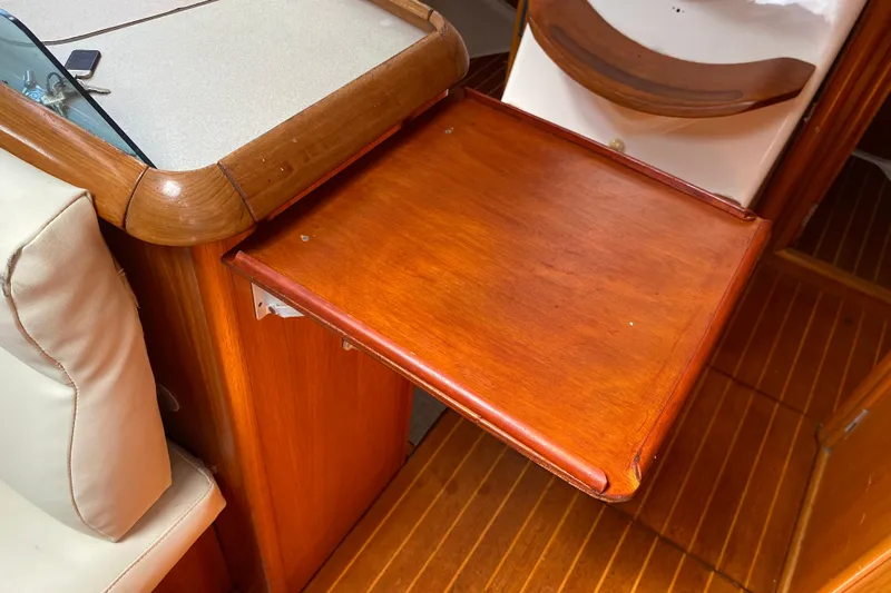  Yacht Photos Pics Wooden interior table on 2002 Jeanneau Sun Odyssey 40 sailboat, showcasing elegant craftsmanship.