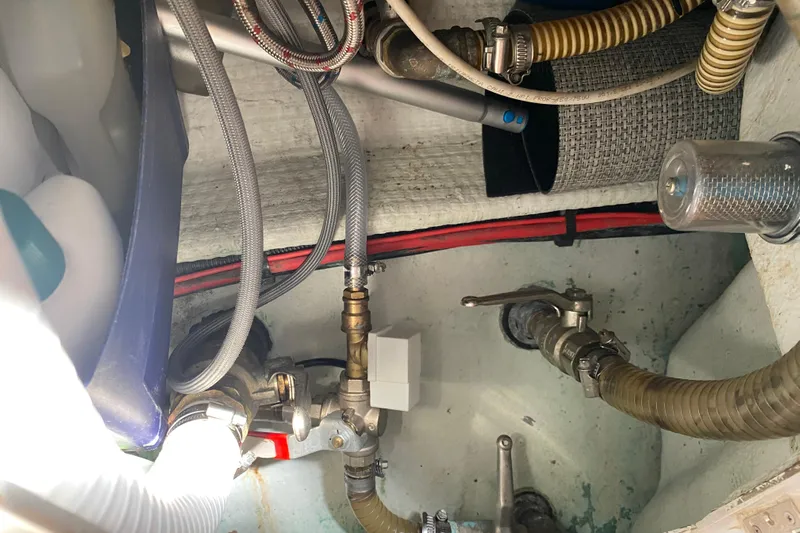  Yacht Photos Pics Engine compartment of 2002 Jeanneau Sun Odyssey 40 with hoses and fittings.