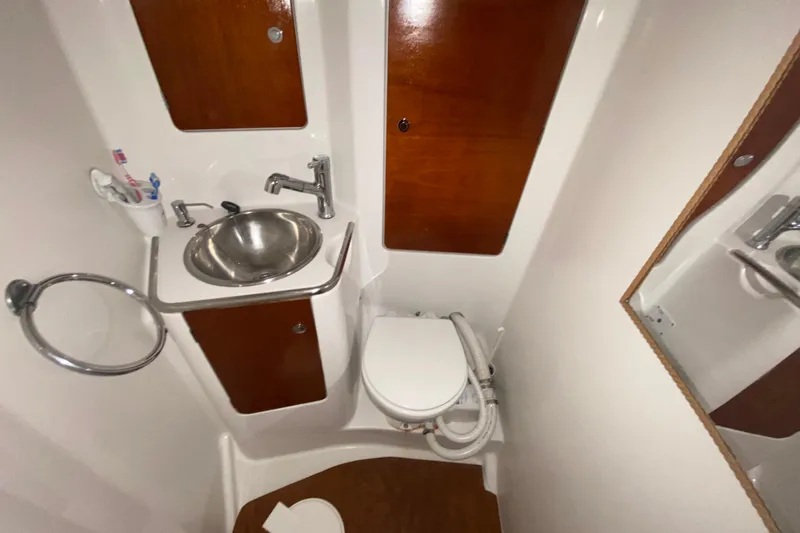  Yacht Photos Pics Compact bathroom in 2002 Jeanneau Sun Odyssey 40 yacht with sink and toilet.