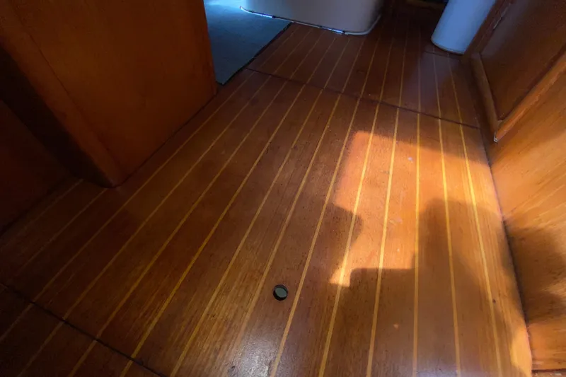 Yacht Photos Pics Wooden interior flooring of a 2002 Jeanneau Sun Odyssey 40 sailboat, showcasing elegant craftsmanship.