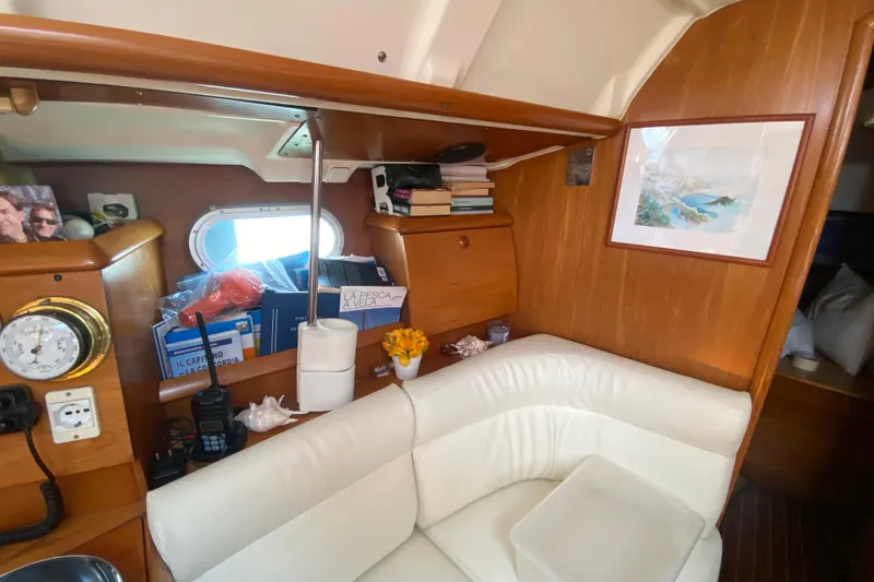  Yacht Photos Pics Cozy interior of 2002 Jeanneau Sun Odyssey 40 sailboat with books and decor.