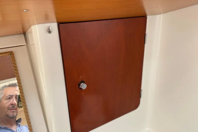  Yacht Photos Pics Interior of 2002 Jeanneau Sun Odyssey 40 yacht with wooden cabinet and mirror reflection.