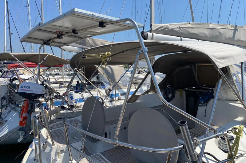  Yacht Photos Pics 2002 Jeanneau Sun Odyssey 40 sailboat with solar panels and covered cockpit in marina.