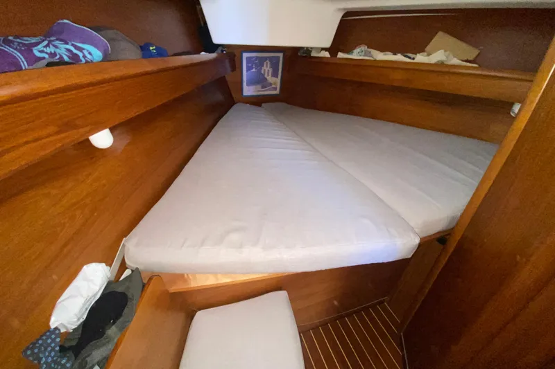  Yacht Photos Pics Cozy cabin interior of 2002 Jeanneau Sun Odyssey 40 sailboat with wooden finish.