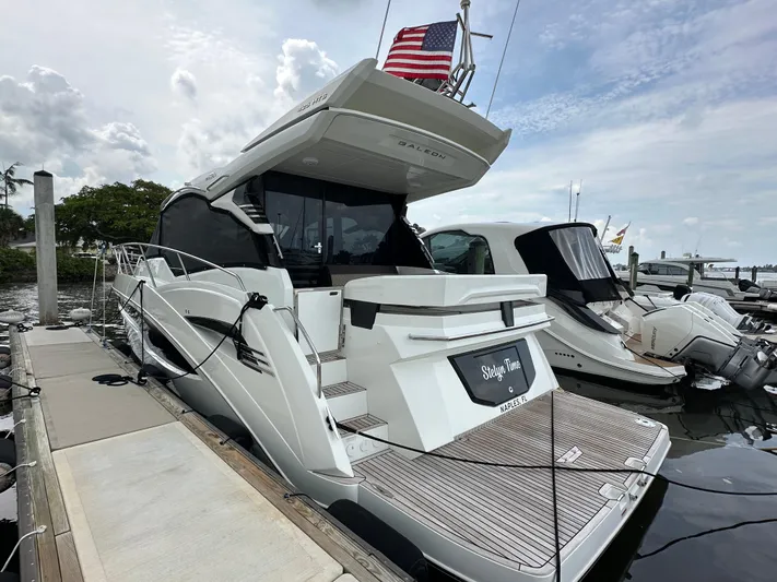 Stelyn Time Yacht Photos Pics 2021 Galeon 425HTS yacht docked, featuring sleek design and American flag.