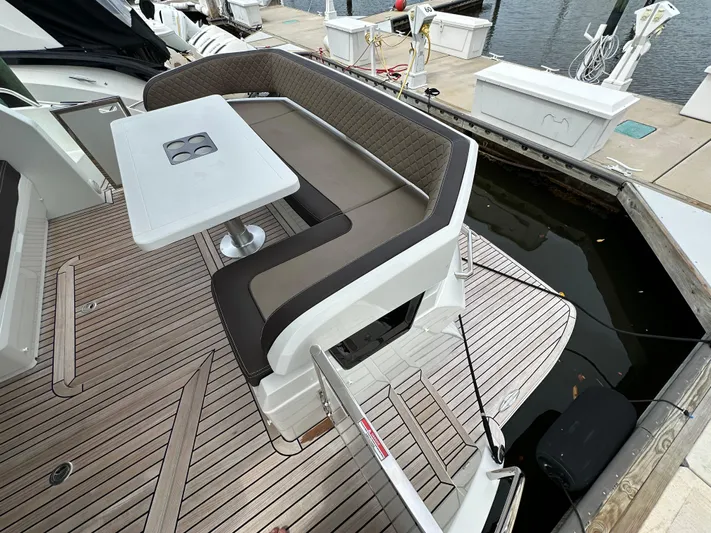 Stelyn Time Yacht Photos Pics Luxury seating area on 2021 Galeon 425HTS yacht with table, docked at marina.