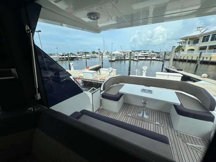 Stelyn Time Yacht Photos Pics Galeon 425HTS 2021 yacht with elegant seating, docked at a marina.