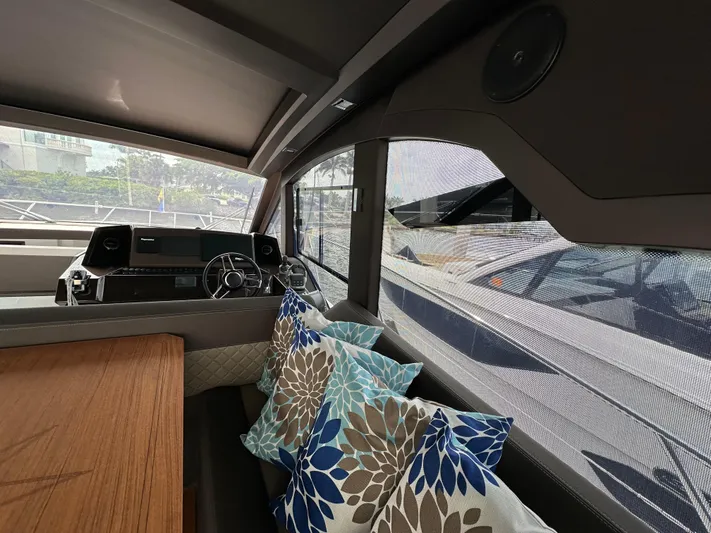 Stelyn Time Yacht Photos Pics Interior of 2021 Galeon 425HTS yacht with steering wheel and decorative cushions.