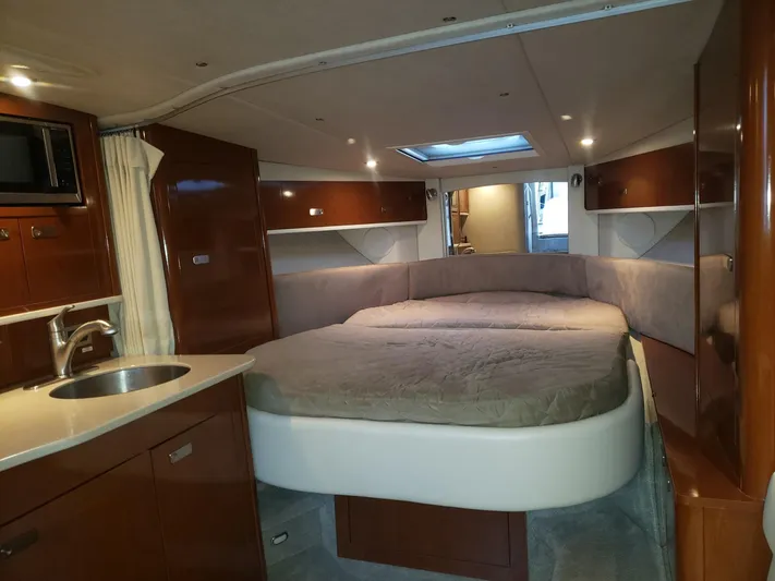 Sol Searching Yacht Photos Pics Luxurious interior of 2011 Sea Ray 350 Sundancer yacht with cozy bed and kitchenette.