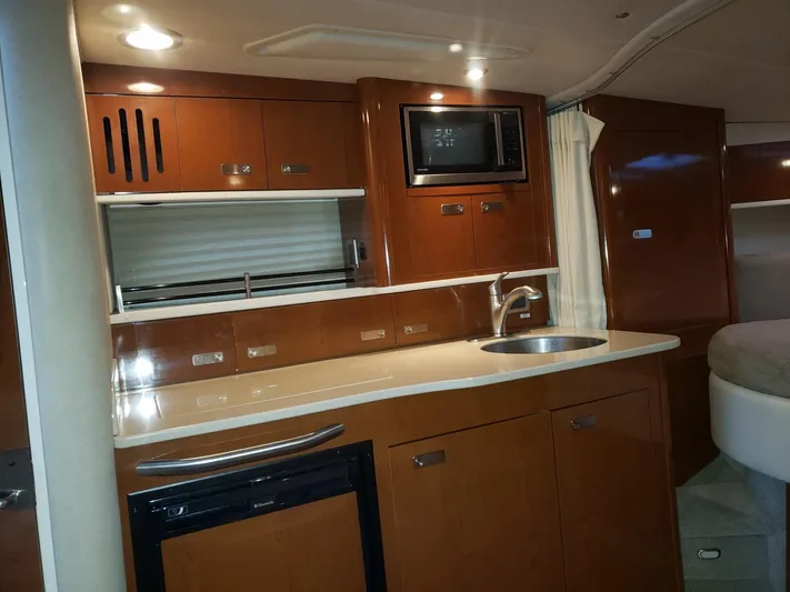 Sol Searching Yacht Photos Pics Interior of 2011 Sea Ray 350 Sundancer yacht with modern kitchen amenities.