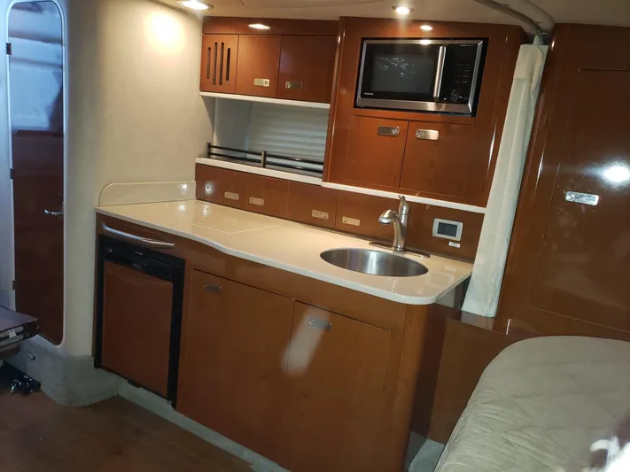 Sol Searching Yacht Photos Pics Interior of 2011 Sea Ray 350 Sundancer yacht with kitchenette and modern amenities.