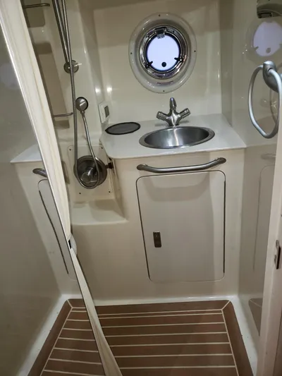 Sol Searching Yacht Photos Pics 2011 Sea Ray 350 Sundancer bathroom with sink, shower, and porthole window.