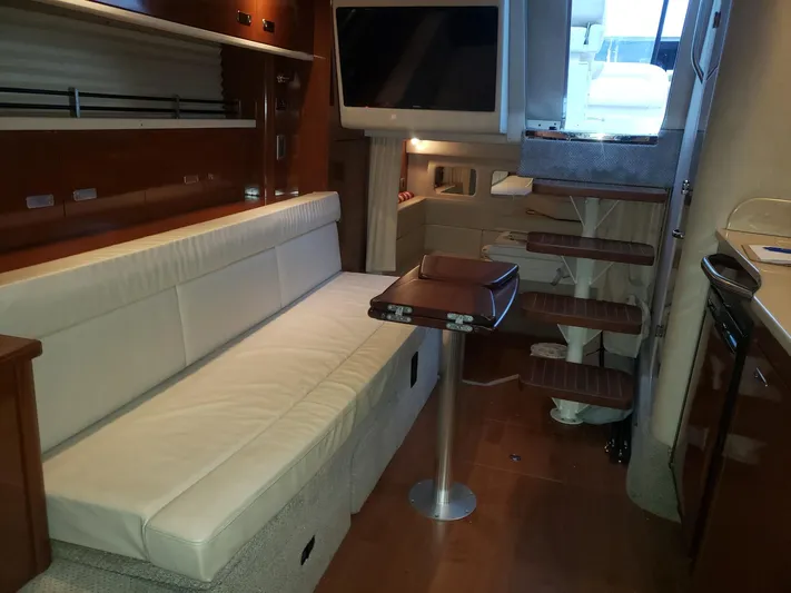 Sol Searching Yacht Photos Pics Interior of 2011 Sea Ray 350 Sundancer with sofa, table, and stairs.