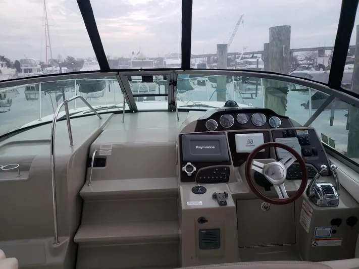 Sol Searching Yacht Photos Pics 2011 Sea Ray 350 Sundancer helm with modern navigation equipment and spacious cockpit.