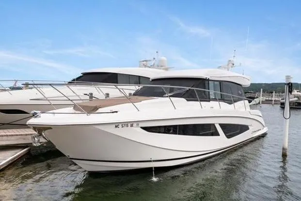 2018 Regal 42 Grand Coupe Yacht Photos Pics 2017 Regal 42 Grande Coupe yacht docked at marina, side view.