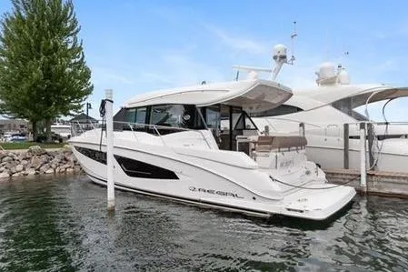 2018 Regal 42 Grand Coupe Yacht Photos Pics 2017 Regal 42 Grande Coupe yacht docked at marina, sleek design, white exterior.