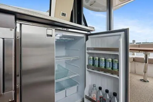 2018 Regal 42 Grand Coupe Yacht Photos Pics Open fridge on 2017 Regal 42 Grande Coupe yacht, stocked with beverages.