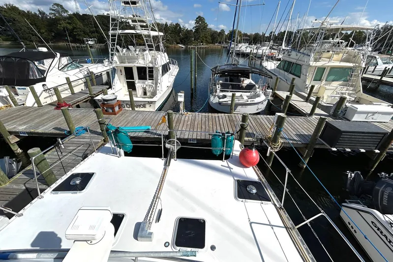 Seahawk Yacht Photos Pics 2004 PDQ 34 Power Catamaran docked among other boats at a marina.