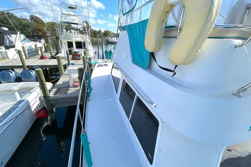Seahawk Yacht Photos Pics 2004 PDQ 34 Power Catamaran docked at marina with clear skies.