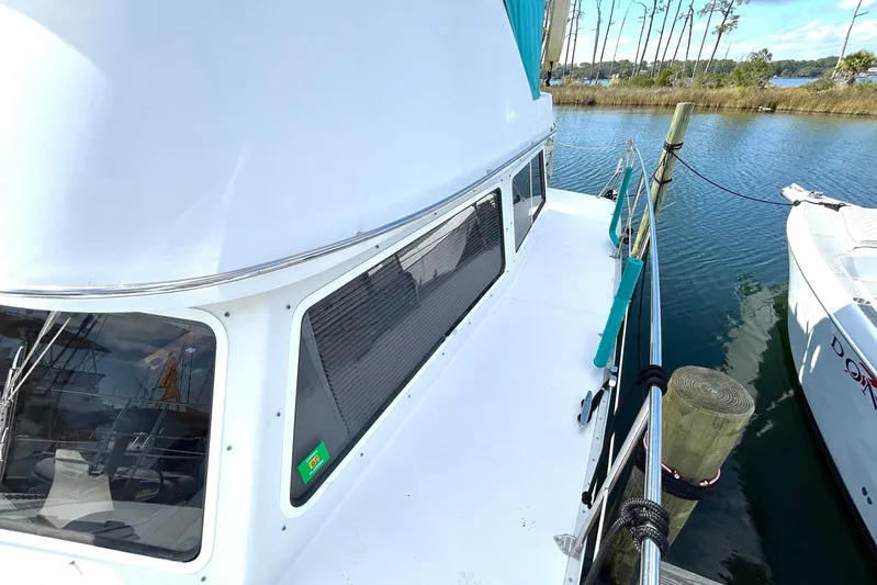 Seahawk Yacht Photos Pics 2004 PDQ 34 Power Catamaran docked, showcasing sleek design and spacious deck.