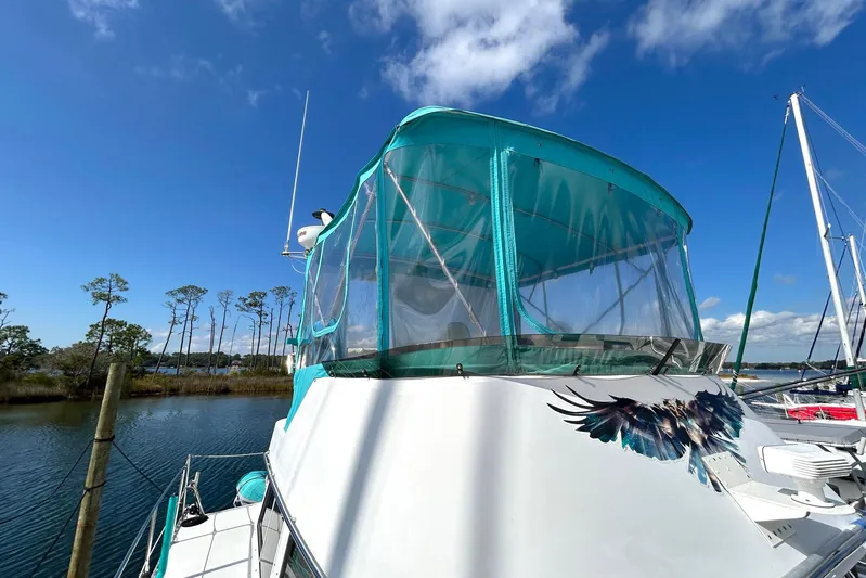 Seahawk Yacht Photos Pics 2004 PDQ 34 Power Catamaran with turquoise canopy and bird graphic on a sunny day.