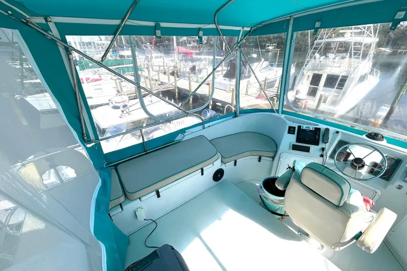 Seahawk Yacht Photos Pics Interior view of 2004 PDQ 34 Power Catamaran helm with teal seating and controls.