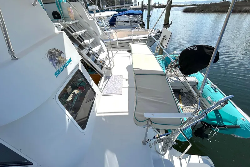 Seahawk Yacht Photos Pics 2004 PDQ 34 Power Catamaran deck with seating and turquoise dinghy.