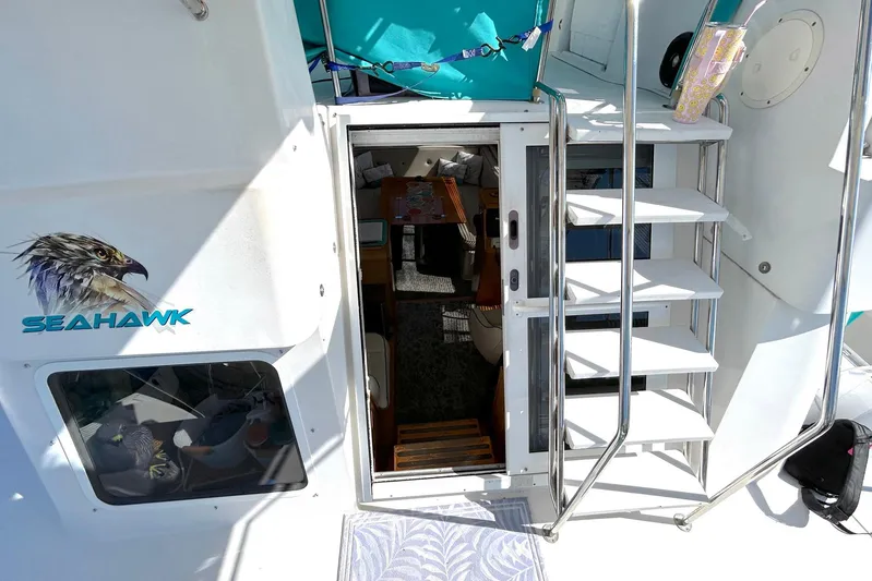 Seahawk Yacht Photos Pics 2004 PDQ 34 Power Catamaran interior view with stairs and "Seahawk" logo.