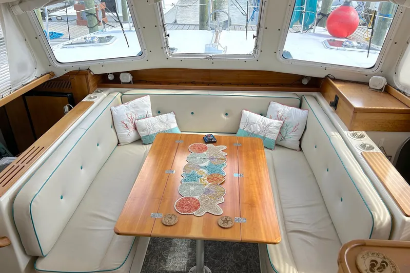 Seahawk Yacht Photos Pics Interior of 2004 PDQ 34 Power Catamaran with cozy seating and decorative pillows.