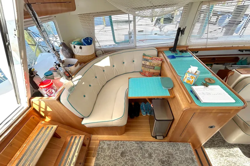 Seahawk Yacht Photos Pics Interior of 2004 PDQ 34 Power Catamaran with cozy seating and nautical decor.