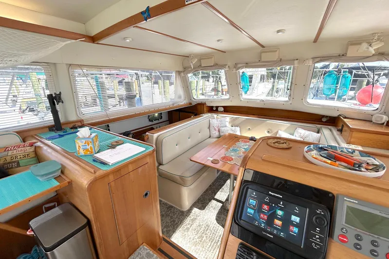 Seahawk Yacht Photos Pics Interior of 2004 PDQ 34 Power Catamaran with cozy seating and navigation equipment.