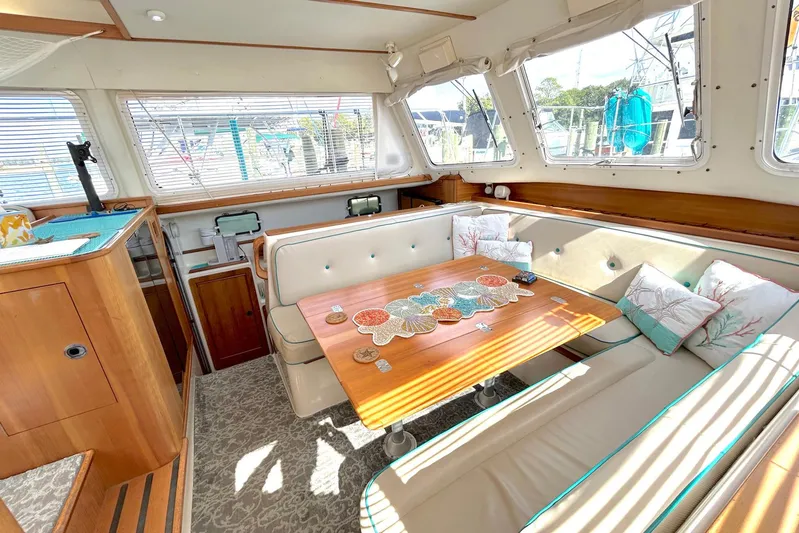Seahawk Yacht Photos Pics Interior of 2004 PDQ 34 Power Catamaran with cozy seating and nautical decor.