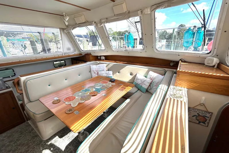 Seahawk Yacht Photos Pics Interior of 2004 PDQ 34 Power Catamaran with cozy seating and decorative table.