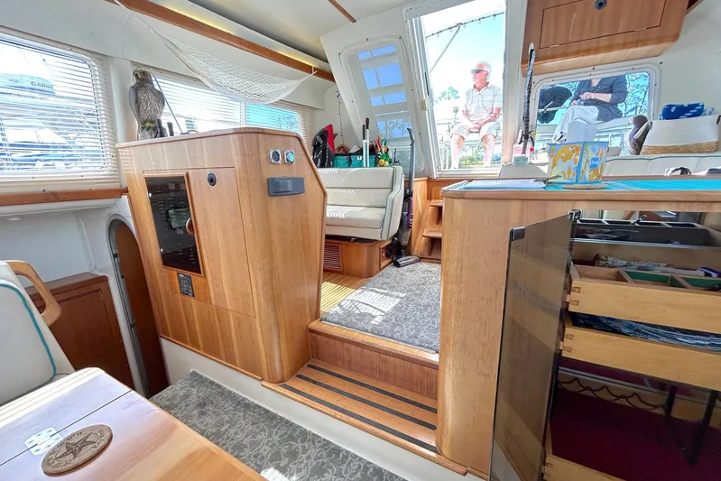 Seahawk Yacht Photos Pics Interior of 2004 PDQ 34 Power Catamaran with wood finishes and seating area.