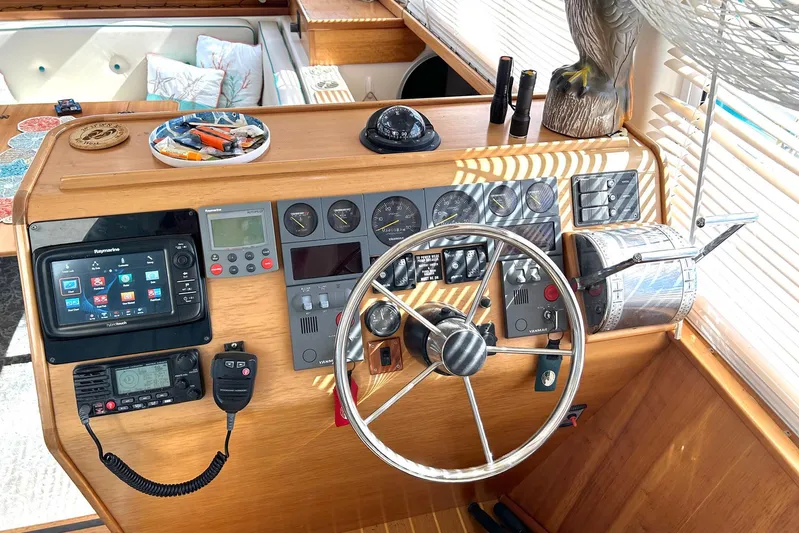 Seahawk Yacht Photos Pics Helm of 2004 PDQ 34 Power Catamaran with navigation equipment and steering wheel.