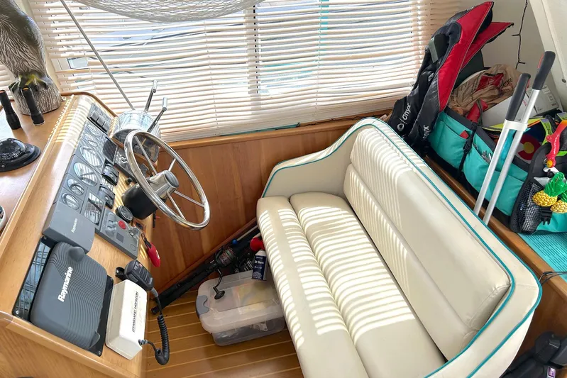 Seahawk Yacht Photos Pics Helm of 2004 PDQ 34 Power Catamaran with steering wheel, controls, and cushioned seating.