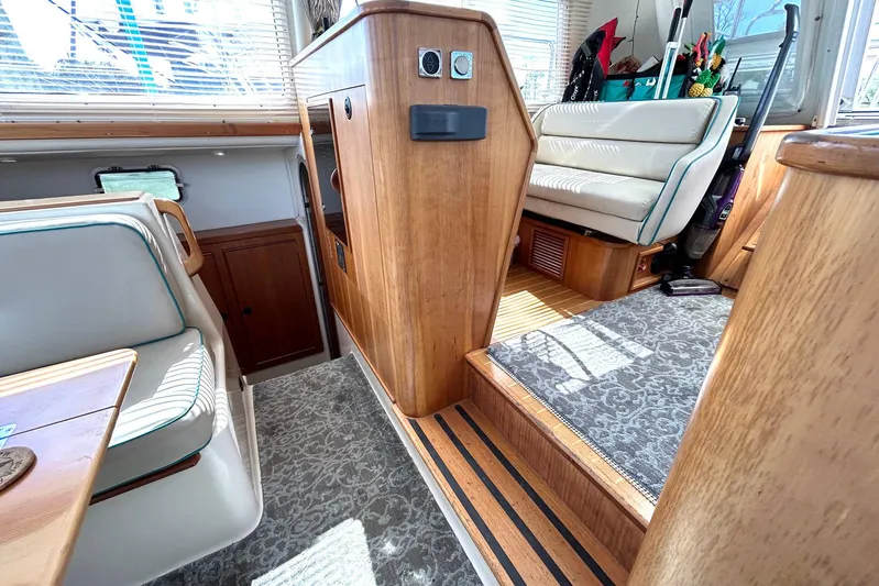 Seahawk Yacht Photos Pics Interior of 2004 PDQ 34 Power Catamaran with wood accents and seating area.