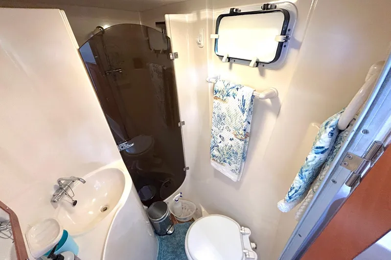 Seahawk Yacht Photos Pics Bathroom interior of 2004 PDQ 34 Power Catamaran with sink, toilet, and shower.