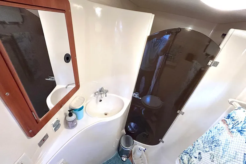 Seahawk Yacht Photos Pics Bathroom interior of 2004 PDQ 34 Power Catamaran with sink, mirror, and shower.