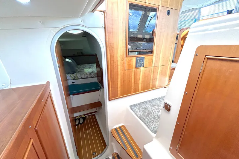 Seahawk Yacht Photos Pics Interior of 2004 PDQ 34 Power Catamaran, featuring wood paneling and cozy cabin space.