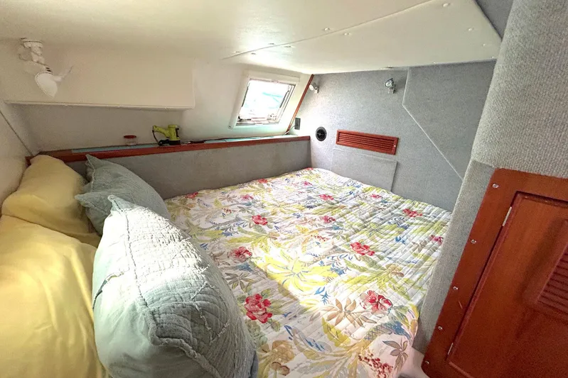 Seahawk Yacht Photos Pics Cozy cabin interior of 2004 PDQ 34 Power Catamaran with floral bedding and soft lighting.