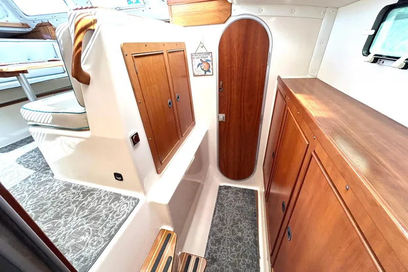 Seahawk Yacht Photos Pics 2004 PDQ 34 Power Catamaran interior with wooden cabinets and seating area.