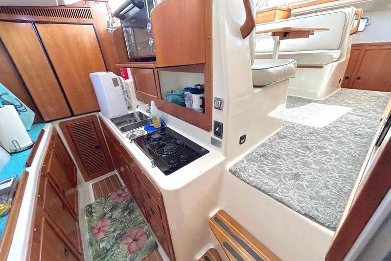 Seahawk Yacht Photos Pics 2004 PDQ 34 Power Catamaran interior with kitchen and dining area.