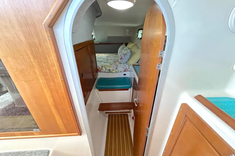 Seahawk Yacht Photos Pics 2004 PDQ 34 Power Catamaran interior with cozy cabin and wooden accents.