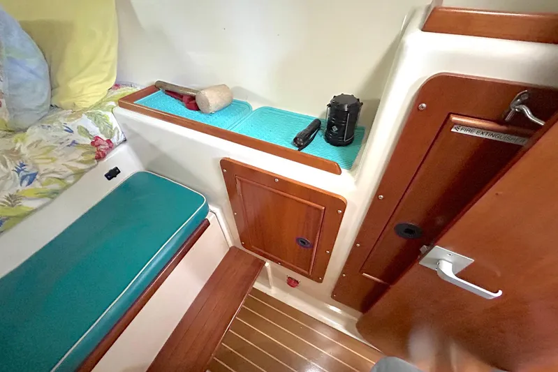 Seahawk Yacht Photos Pics Interior of 2004 PDQ 34 Power Catamaran with wooden accents and seating area.