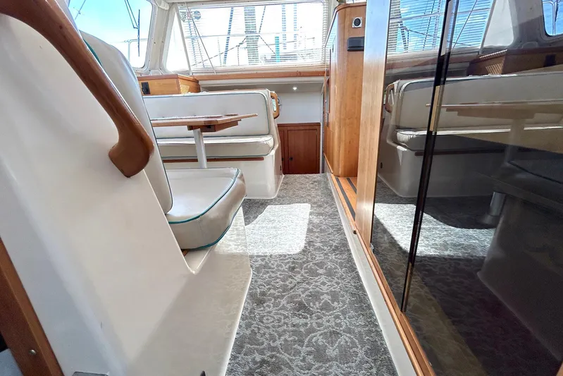 Seahawk Yacht Photos Pics Interior of 2004 PDQ 34 Power Catamaran with seating and wooden accents.