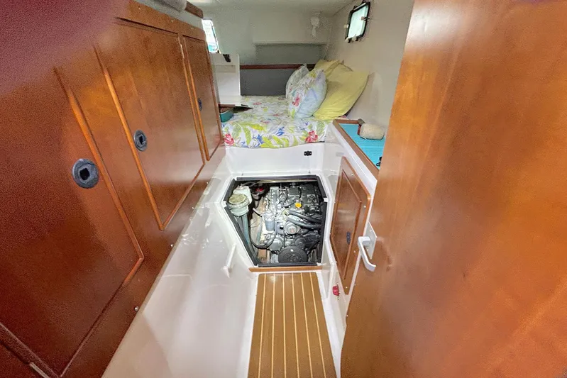 Seahawk Yacht Photos Pics 2004 PDQ 34 Power Catamaran interior with engine access and cozy cabin.
