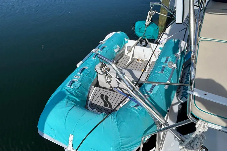 Seahawk Yacht Photos Pics 2004 PDQ 34 Power Catamaran with turquoise inflatable dinghy on deck.