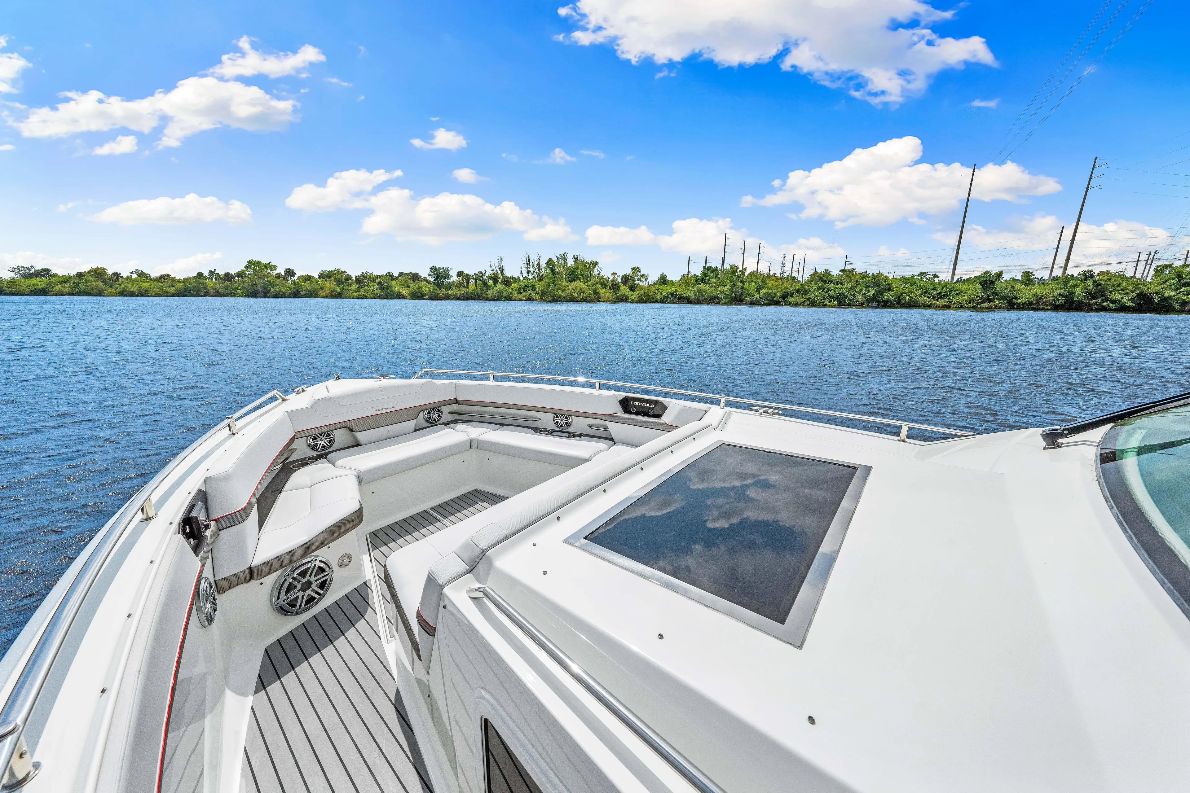 Ski 2 Sea Yacht Photos Pics 2017 Formula 430 Super Sport Crossover boat on a serene lake with blue sky.
