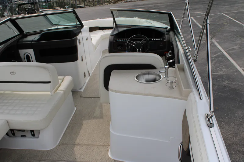  Yacht Photos Pics 2020 Cobalt R30 boat interior with seating, steering wheel, and built-in sink.